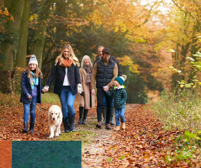 Three-generation family walking in autumn woodland, representing family business succession and inheritance tax planning