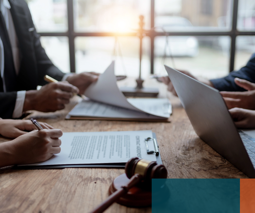 Legal and accounting advisers reviewing contracts with a business owner